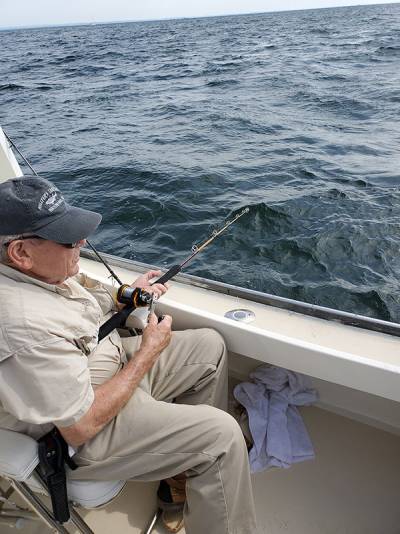 Guest posing with fish on deck